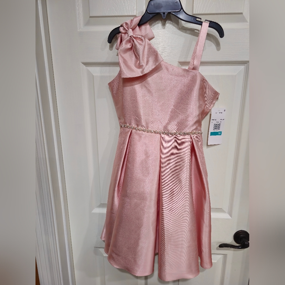 A high-low dress is highlighted by a charming asymmetrical neckline. Girl 16